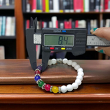 7 Chakra Bracelet featuring colorful healing stones and white Howlite beads, stretchable and lab-certified for spiritual balance