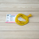 A 108+1 bead Natural Yellow Agate Mala made of polished 6mm yellow hakik stones, perfect for chanting and wearing