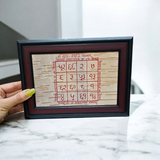 A Handmade Sukh Samridhi Yantra on Bhojpatra with a frame, designed to bring prosperity, wealth, and happiness to the worshipper's life