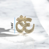 A close-up image of the Om Tilak Sancha, a brass stamp used for applying sacred Om tilak on the forehead during worship rituals and religious ceremonies.
