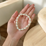 A lab-certified natural pearl bracelet featuring 10-11mm white pearls, elegantly strung together for spiritual and fashionable wear