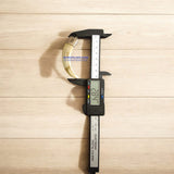 A lab-certified wild boar tooth pendant encased in a polished silver cap, displayed on a velvet box with a certificate of authenticity