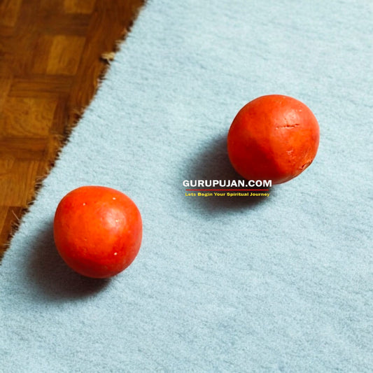 A set of two natural Goulochan (Gorochan) balls placed on a sacred cloth, ready for making Yantras, Tilak, or use in spiritual remedies