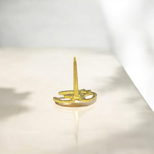An image of the Om Tilak Stamp, a spiritual tool used for applying tilak on the forehead for meditation and religious ceremonies.