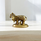 Brass Kamdhenu Cow Murti with calf and deities, ideal for spiritual rituals, pooja, and Vastu correction