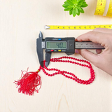 Close-up image of a lab-certified Red Coral Mala with 4MM beads and 108+1 bead count, perfect for chanting and meditation