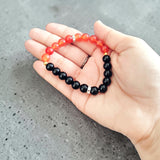 Description of the image: A beautiful Hessonite and Black Agate Bracelet featuring 8MM beads in a stretchable design with natural stones for spiritual healing