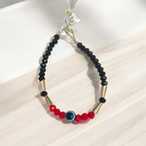 Evil Eye Anklet for Kids with black and red beads, designed for spiritual protection and good luck.