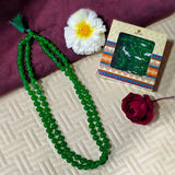 Green Agate Mala with 108 beads displayed on a spiritual setup, showcasing natural green hues and smooth polished finish