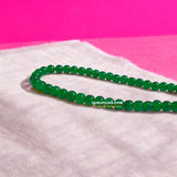 Green Agate Mala with 108 beads displayed on a spiritual setup, showcasing natural green hues and smooth polished finish