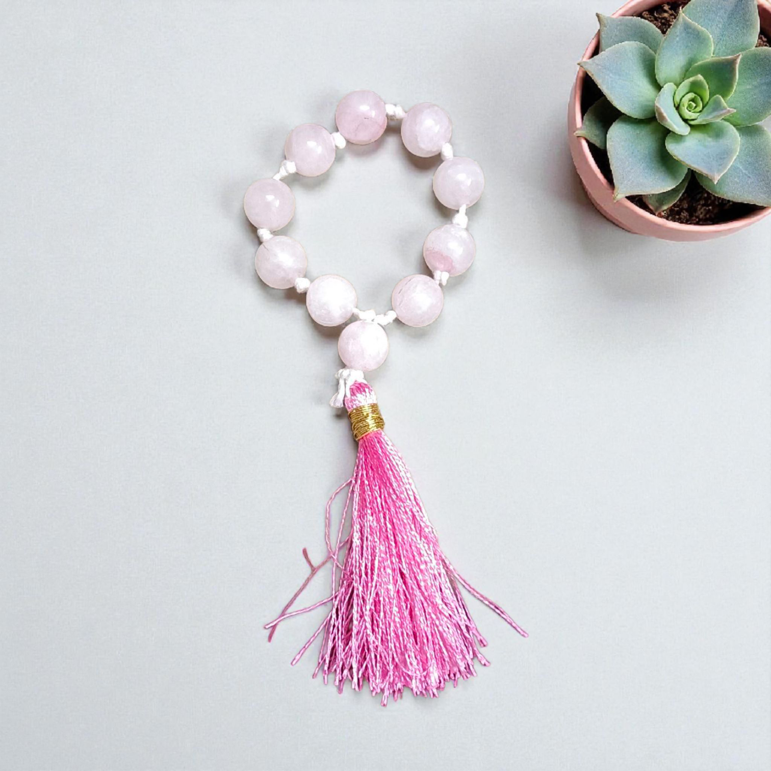 Image of a Natural Rose Quartz Finger Mala with 9+1 lab-certified 8mm beads, designed for meditation, peace, and emotional healing