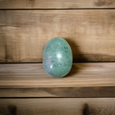 Image of handcrafted greenish black Shivling stone ideal for Tulsi plant, temple, or garden use