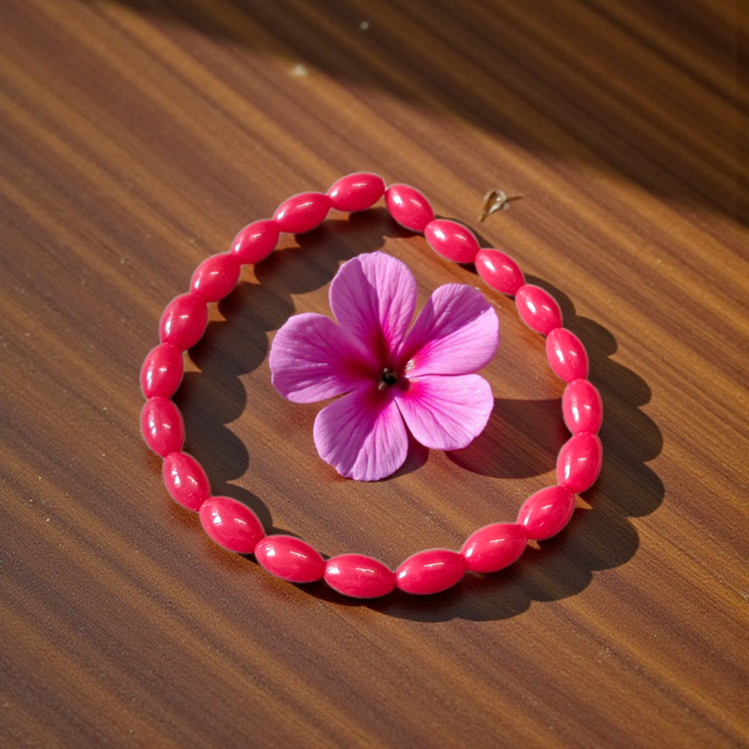 Lab Certified Lal Monga (Red Coral) Bracelet with polished red beads placed on a traditional cloth backdrop