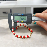 Natural Red and White Gunja bracelet with 5mm lab certified beads on stretchable cord, displayed on a neutral background