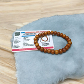 Natural White Sandalwood Bracelet with 8mm round stretchable beads, lab certified, displayed on a wooden surface