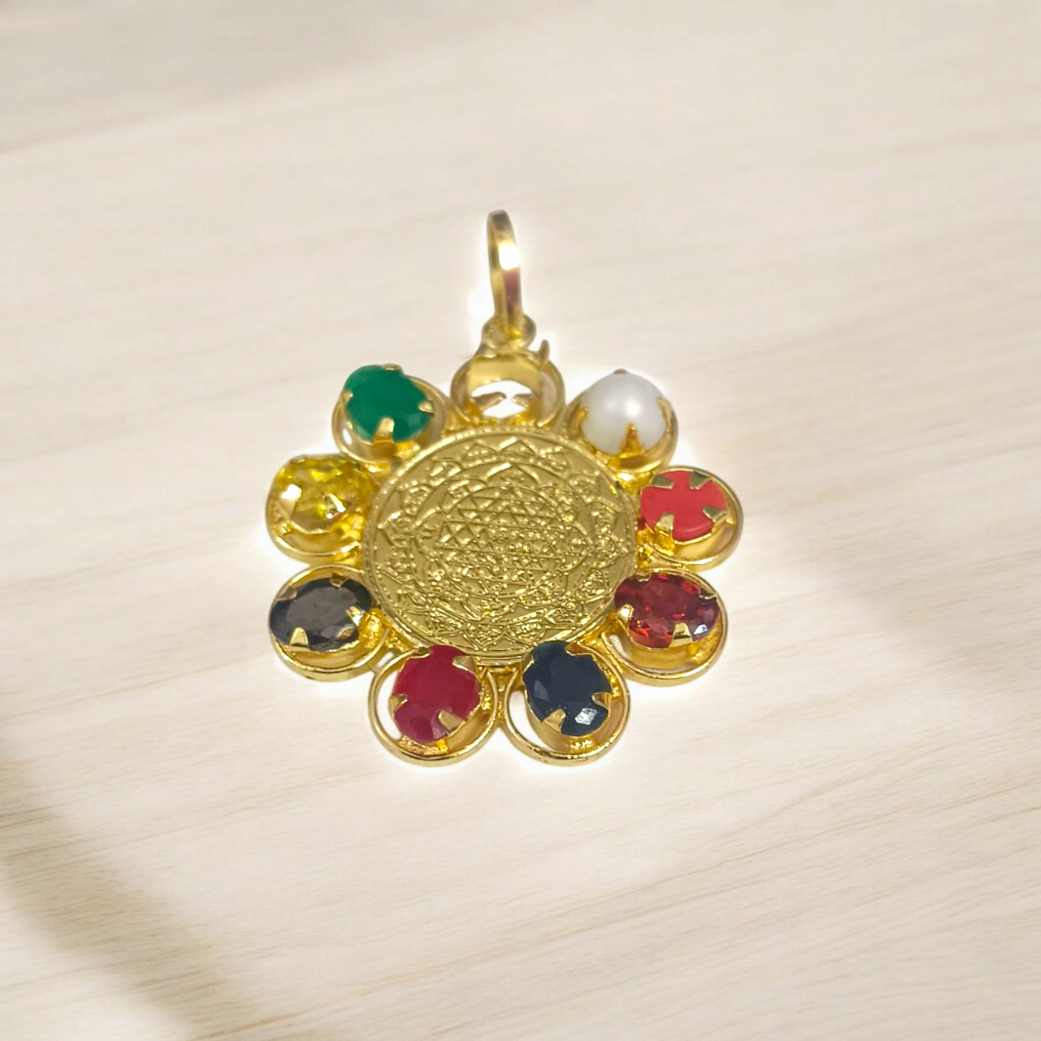 Navratna Locket with Shri Yantra – Nine gemstones pendant with sacred Shri Yantra symbol, gold-plated chain, offering spiritual protection, prosperity, and divine blessings.