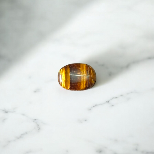 Polished Original Tiger Eye Stone with natural brown and golden bands, used for confidence, willpower, and meditation