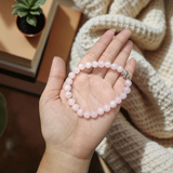 Rose Quartz Bracelet with 8mm natural pink beads, stretchable, lab certified, displayed on a neutral background