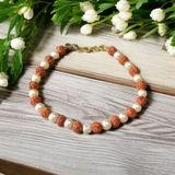 Rudraksha and Moti (Pearl) Bracelet with elegant design, stretchable, placed on a spiritual fabric background