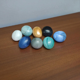 Set of 8 multicolor shiny round glass pebble stones placed in plant pots, vases, and aquariums