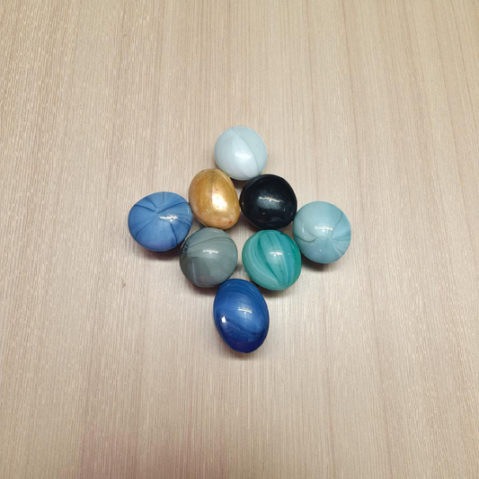 Set of 8 multicolor shiny round glass pebble stones placed in plant pots, vases, and aquariums