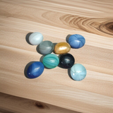 Set of 8 multicolor shiny round glass pebble stones placed in plant pots, vases, and aquariums