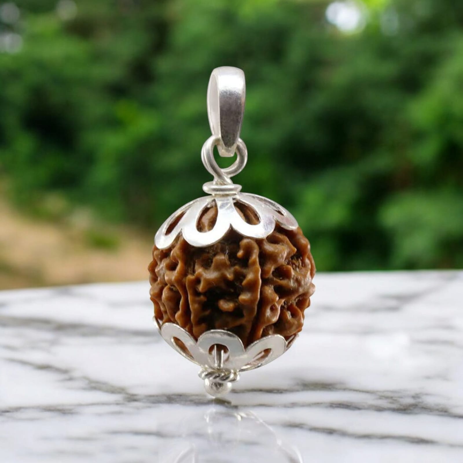 9 Mukhi Rudraksha bead, representing Goddess Durga's blessings for empowerment, protection, and spiritual growth