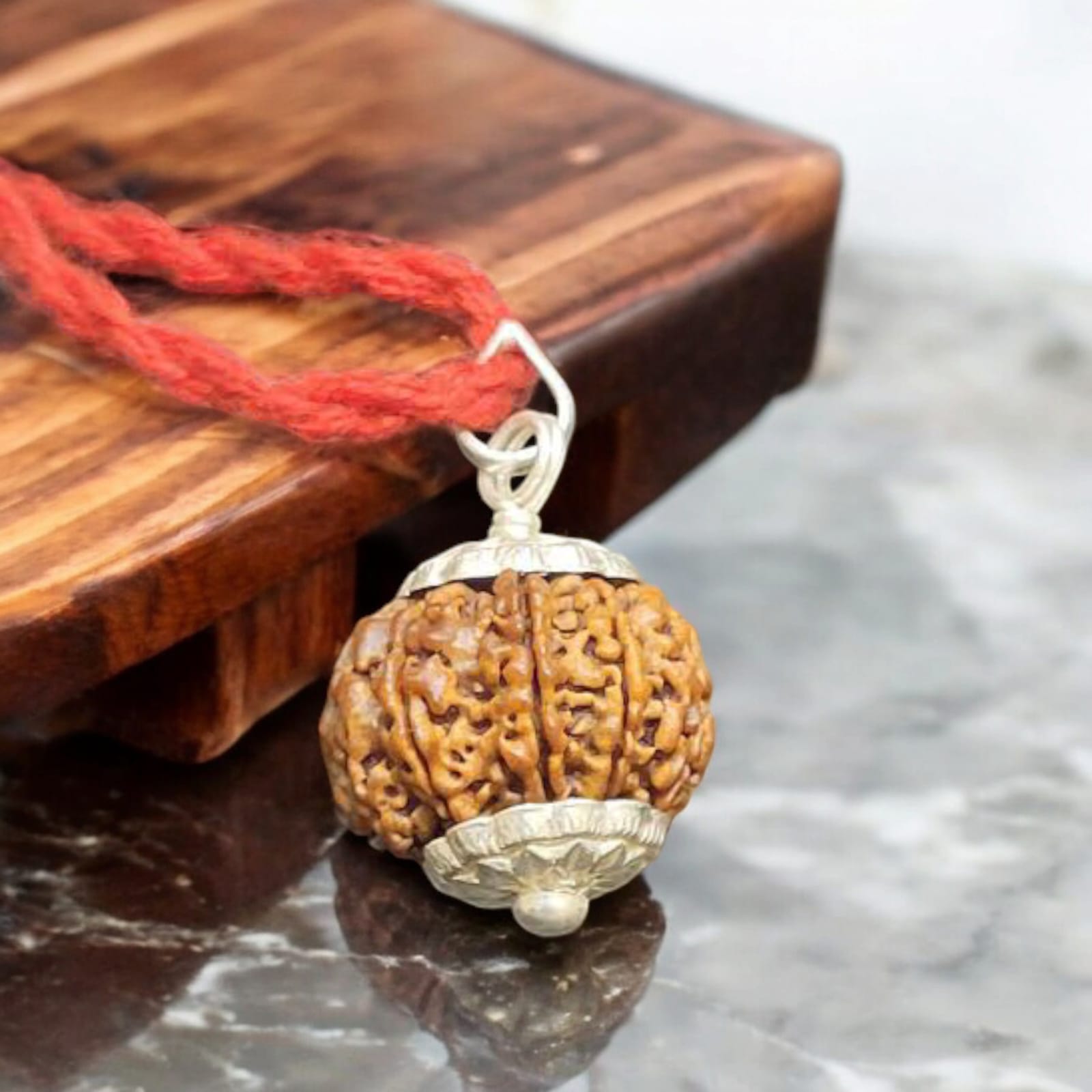 9 Mukhi Rudraksha bead, representing Goddess Durga's blessings for empowerment, protection, and spiritual growth
