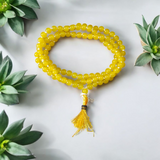 A 108+1 bead Natural Yellow Agate Mala made of polished 6mm yellow hakik stones, perfect for chanting and wearing