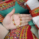 A Laddu Gopal Mala made with pearls and zircon stones, designed for adorning small Krishna idols. The elegant garland adds beauty and divine charm to the idol.