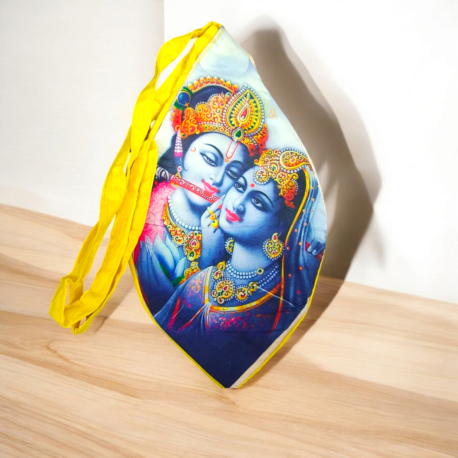 A Radha Krishna Gomukh Bag with a vibrant digital colourful print, ideal for storing prayer beads and spiritual essentials during mantra japa.