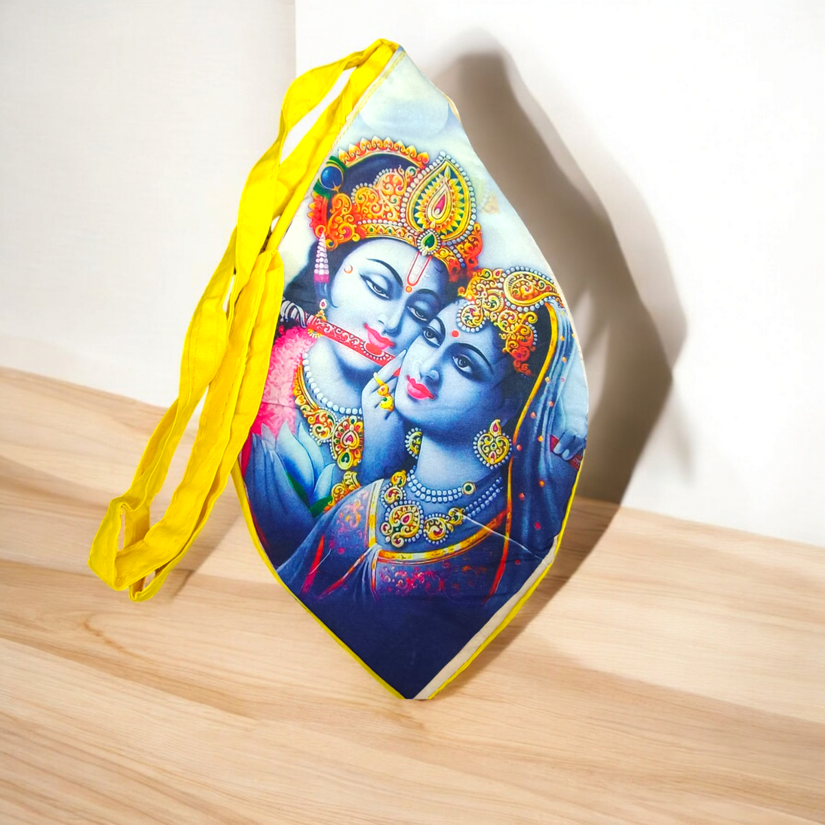 A Radha Krishna Gomukh Bag with a vibrant digital colourful print, ideal for storing prayer beads and spiritual essentials during mantra japa.
