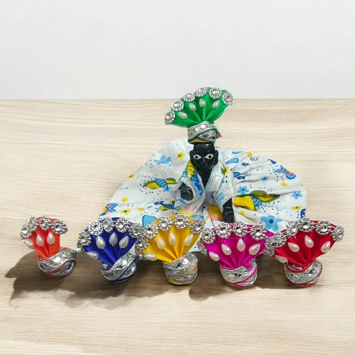 A Set of 6 Laddu Gopal Pagdis (crowns) designed for size 0 No. Krishna idols, perfect for adorning your Bal Gopal idol during daily worship, prayers, and festive occasions.