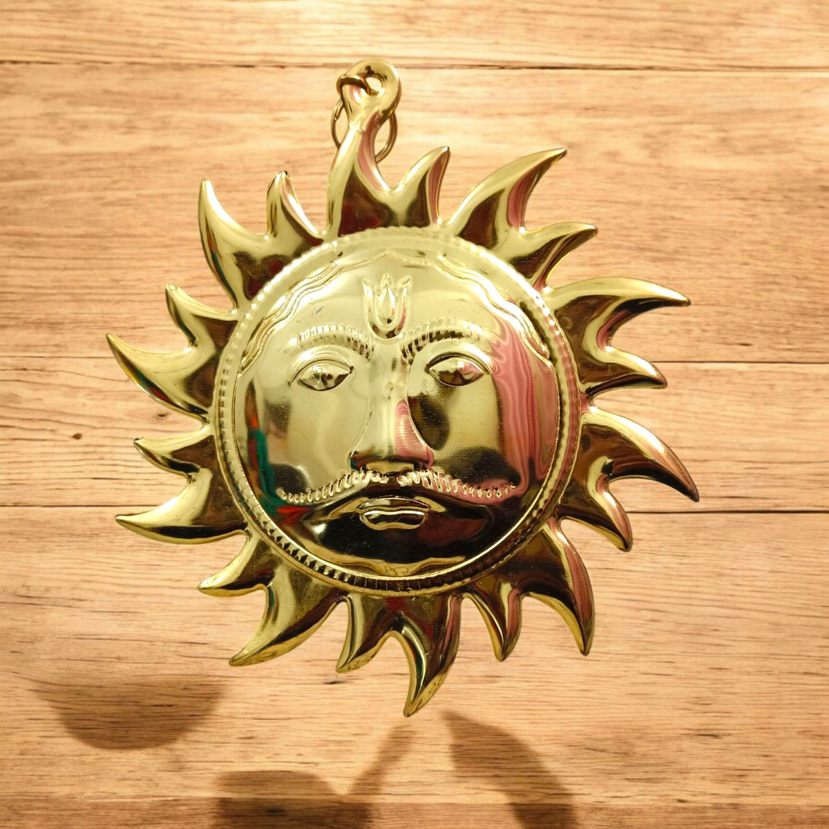 A Wall Hanging Sun made of pure brass with a golden finish, designed to protect from Vaastu dosh, Shani dosh, and accidents, while inviting prosperity and positive energy into your space