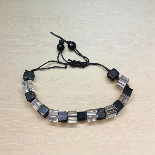A beautiful black and white crystal bracelet designed for attraction, energy balance, and healing, displayed on a neutral background