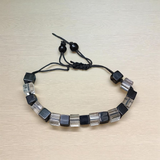 A beautiful black and white crystal bracelet designed for attraction, energy balance, and healing, displayed on a neutral background