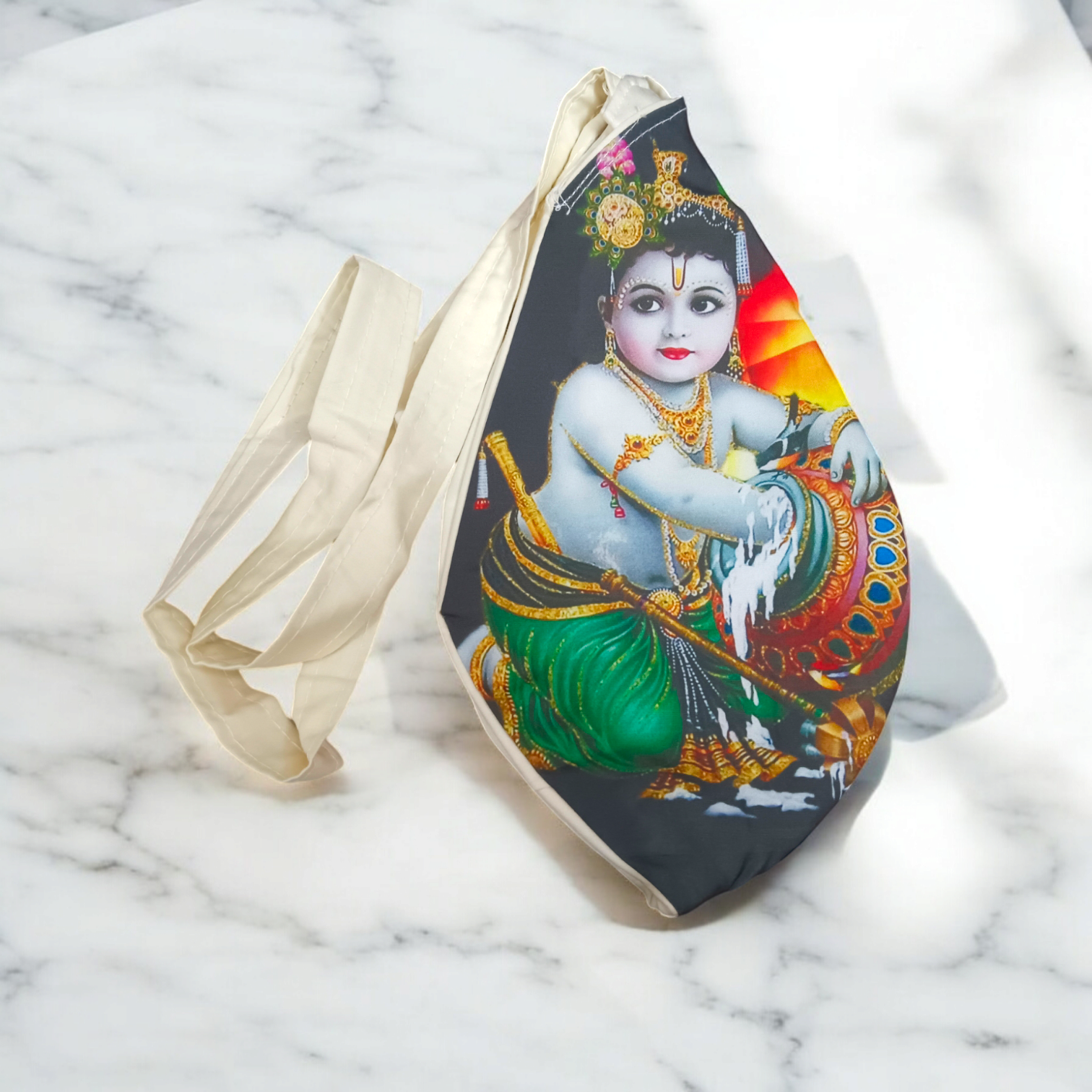 A beautifully crafted Laddu Gopal Gomukhi Bag with a Makhan Chor design, made from soft cotton.