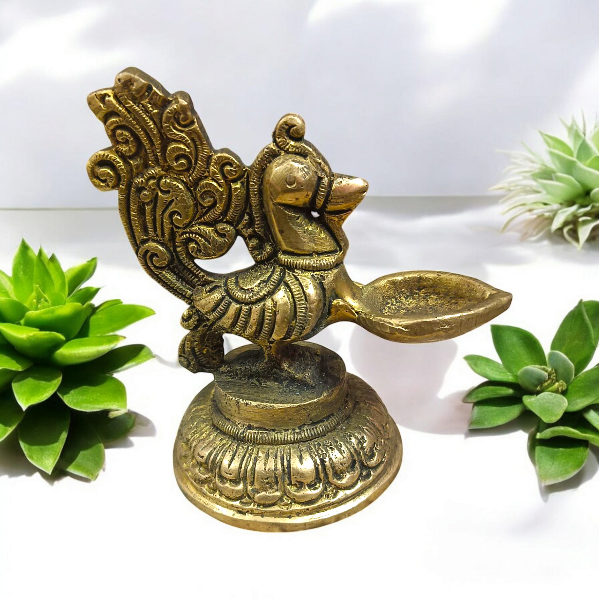 A beautifully crafted Peacock Brass Jyot with Nakshi peacock design, ideal for use in pooja rooms and spiritual spaces.