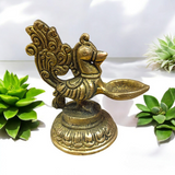 A beautifully crafted Peacock Brass Jyot with Nakshi peacock design, ideal for use in pooja rooms and spiritual spaces.
