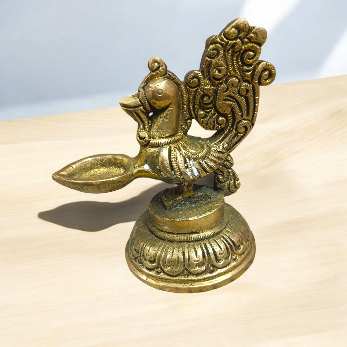 A beautifully crafted Peacock Brass Jyot with Nakshi peacock design, ideal for use in pooja rooms and spiritual spaces.