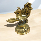 A beautifully crafted Peacock Brass Jyot with Nakshi peacock design, ideal for use in pooja rooms and spiritual spaces.
