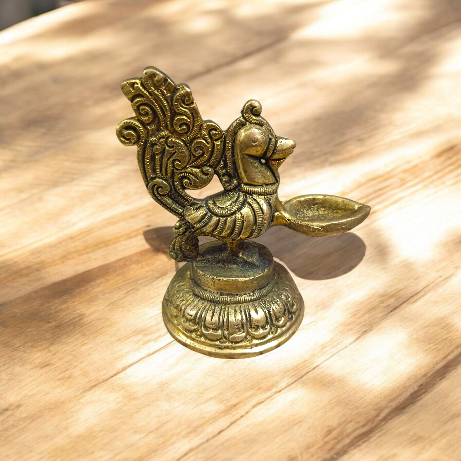 A beautifully crafted Peacock Brass Jyot with Nakshi peacock design, ideal for use in pooja rooms and spiritual spaces.