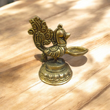 A beautifully crafted Peacock Brass Jyot with Nakshi peacock design, ideal for use in pooja rooms and spiritual spaces.