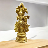 A beautifully crafted brass idol of Lord Krishna, depicting him playing the flute, perfect for worship and home decoration.