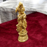 A beautifully crafted brass idol of Lord Krishna, depicting him playing the flute, perfect for worship and home decoration.