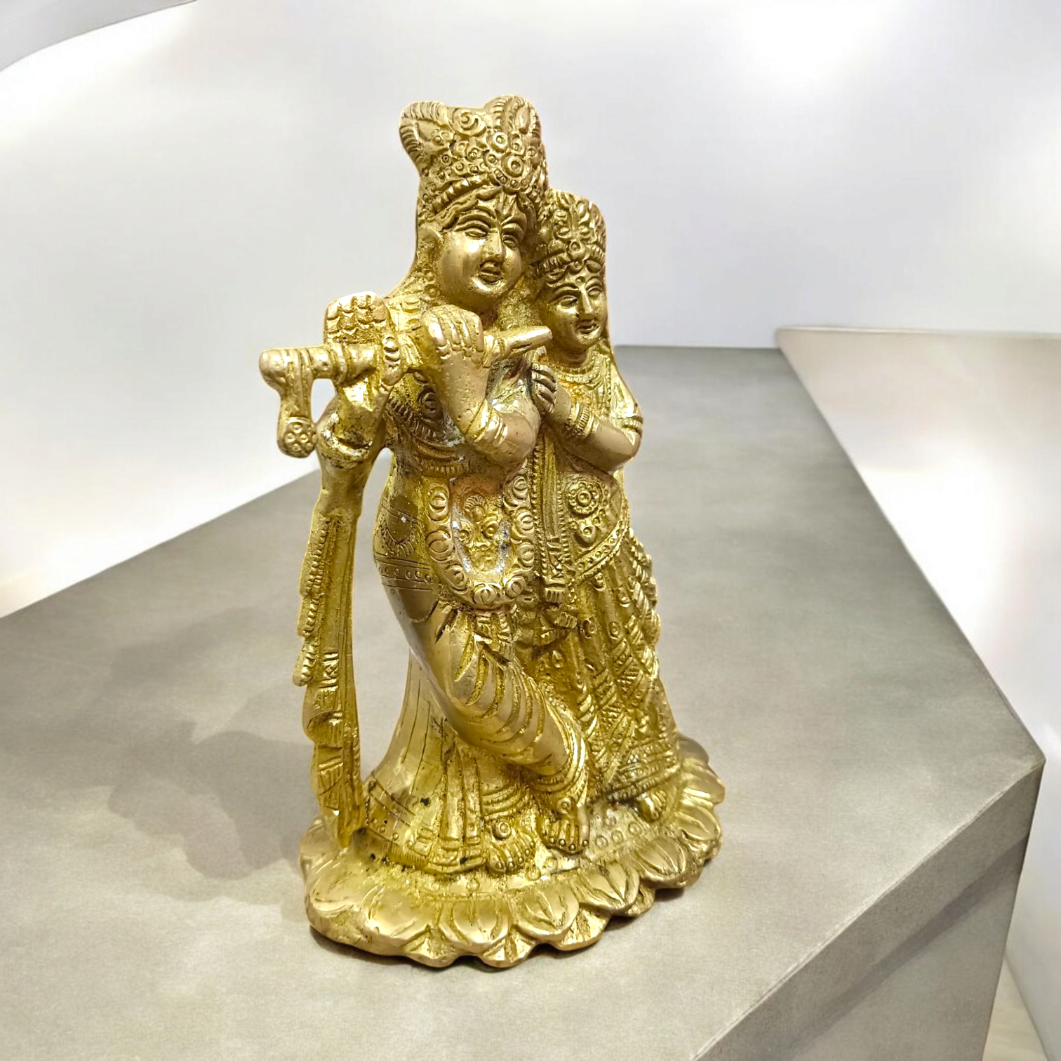 A beautifully crafted brass idol of Radha and Krishna, symbolizing divine love, perfect for worship and home decor.