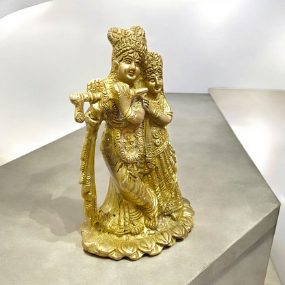A beautifully crafted brass idol of Radha and Krishna, symbolizing divine love, perfect for worship and home decor.