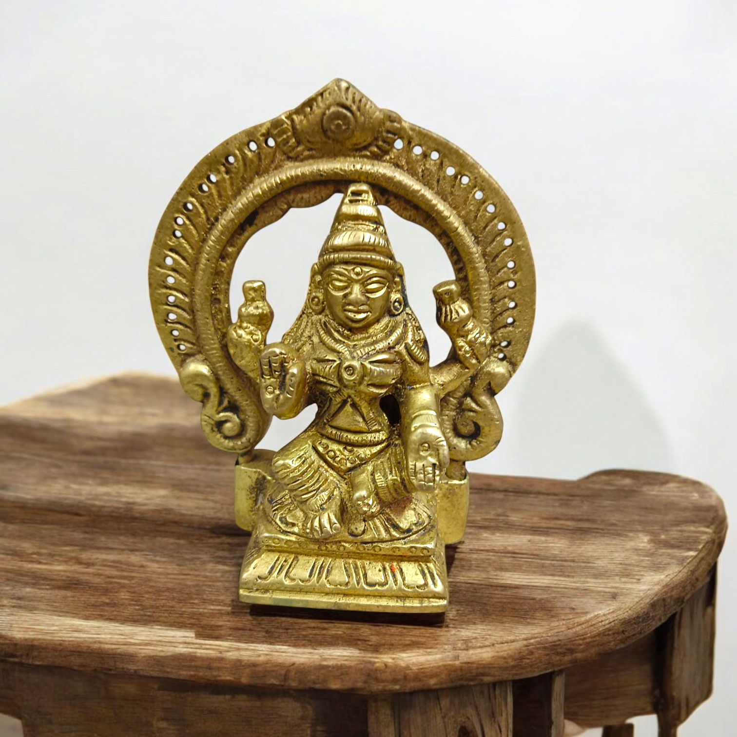 A beautifully crafted brass murti of Goddess Lakshmi, featuring intricate details and a golden finish, symbolizing wealth and prosperity.