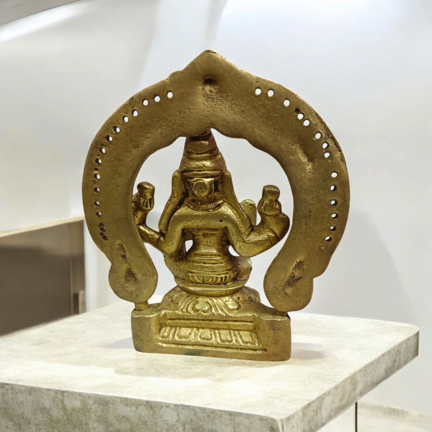 A beautifully crafted brass murti of Goddess Lakshmi, featuring intricate details and a golden finish, symbolizing wealth and prosperity.