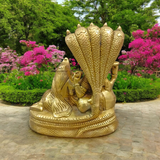 A beautifully crafted brass statue of Lord Lakshmi Narayan resting upon the Shesha Naag, symbolizing wealth, protection, and divine blessings.